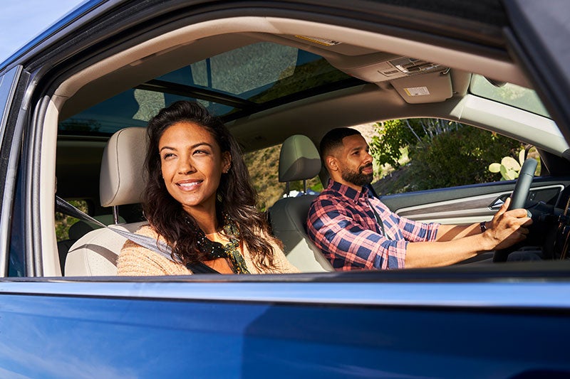 Happy couple traveling in SUV